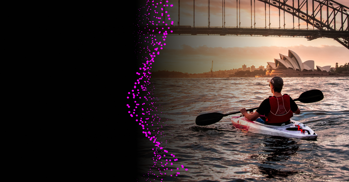 An independent consultant kayaking on Sydney Harbour at sunset