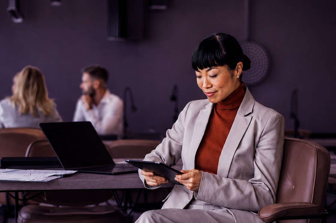 Experienced lawyer reviewing work on a tablet in a modern office